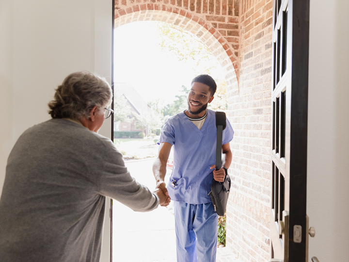 New physical therapist nurse arrives to the home of his patient to help with his weekly exercises.