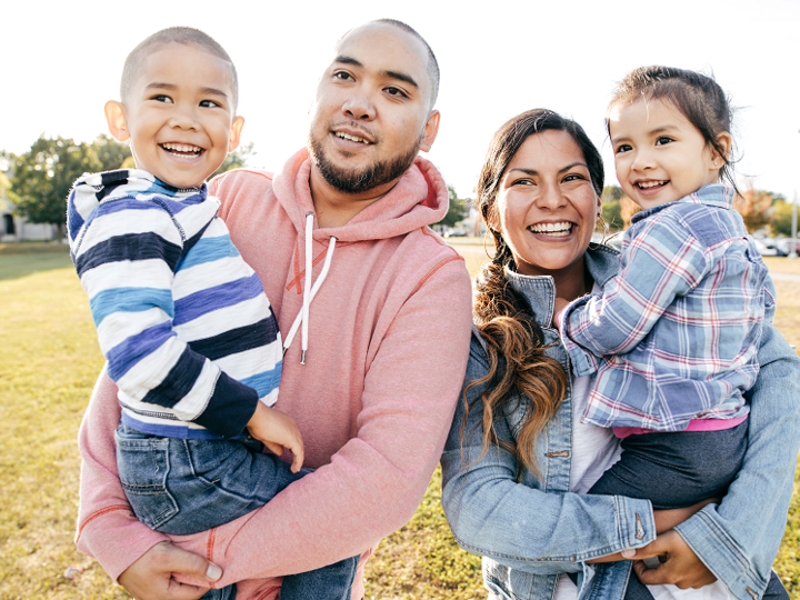 Happy Latin family outdoors.