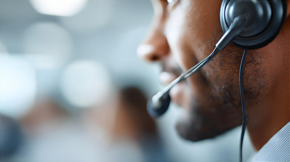 Sideview of man wearing a phone headset